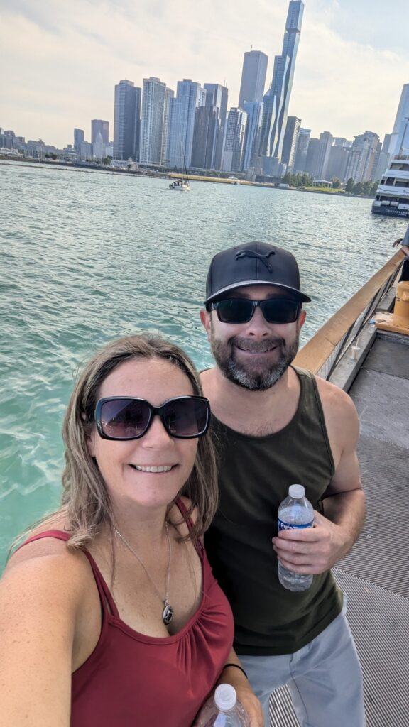 Romantic Chicago adventure: Couple posing on a pier with the city skyline as the backdrop.