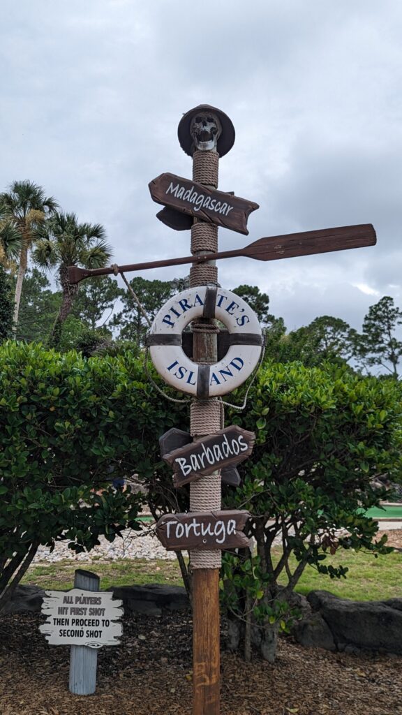 Pirate-themed sign at Pirate’s Island Adventure Golf in Gulf Shores, Alabama, featuring playful designs and vibrant colors.