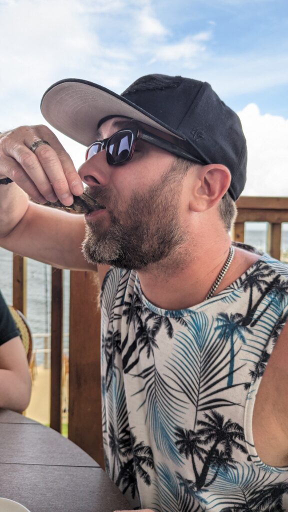 Me slurping a raw oyster at Jess’s on the Bay in Gulf Shores, Alabama, with a delighted expression.